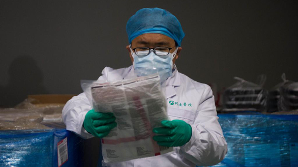 A doctor in Shanghai examines newly-arrived supplies