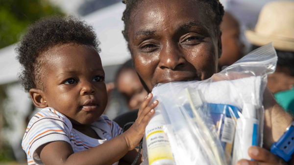 A mom and her baby in the Bahamas receive hygiene supplies