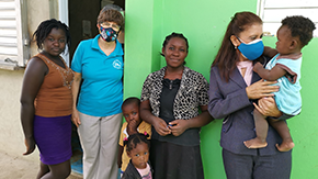 Teresa Narvaez, right, has been with Project HOPE for 31 years, overseeing our maternal and child health work in the Dominican Republic since 1995. She's pictured here with families and young children. Photo courtesy Teresa Narvaez, used with permission.