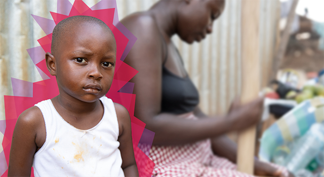 A young boy looks at the camera skeptically as he sits next to his mother.