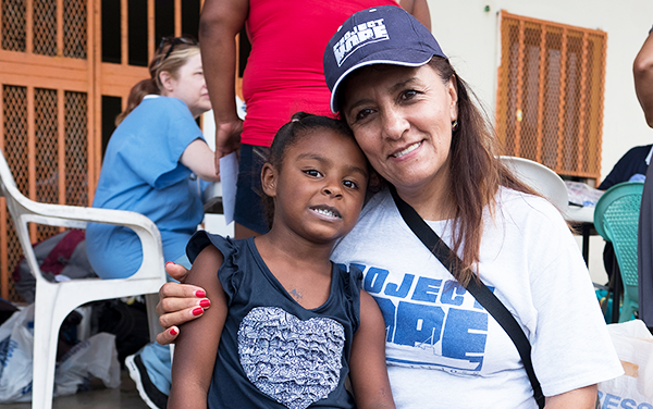 Project HOPE staff person Teresa Narvaez providing aid to a girl in Puerto Rico