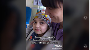 A screenshot of a recent tiktok on Project HOPE's new channel, showing a young child held by her mother in a hospital in Poland that's being supported by Project HOPE.