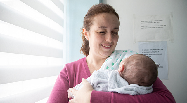 A mother holds her newborn in this hospital in Macedonia.