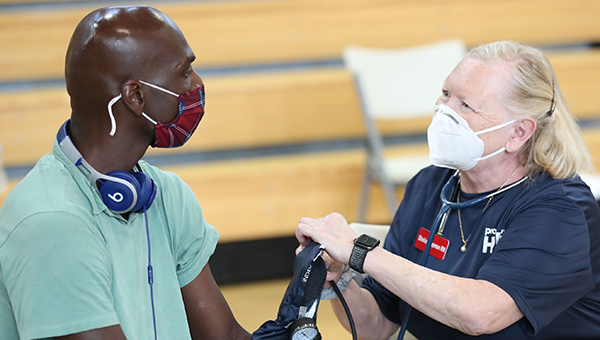 Project HOPE health worker providing assistance after Hurricane Ida.