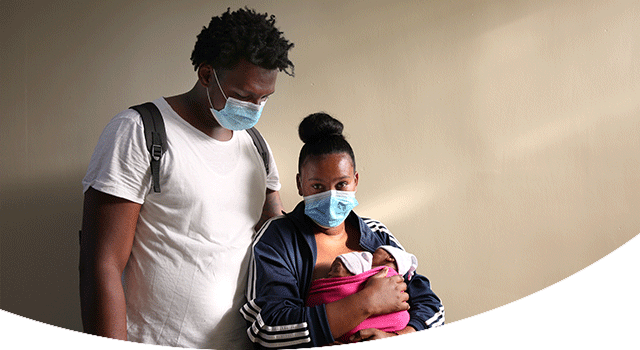 A young couple in the Dominican Republic just had triplets at a hospital supported by Project HOPE. The mother holds two of the babies in a pink wrap, tightly wound around her chest, as her husband looks down at their small faces.