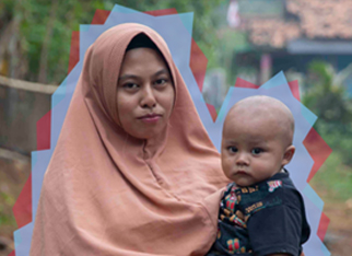 A woman in rural Indonesia holds her young baby who wears a navy outfit. She has a peach-colored head scarf that covers her hair.