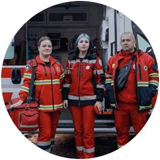 A photograph of Project HOPE-supported health workers in Ukraine standing in front of an ambulance with an open door.