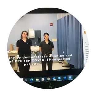 A computer screen shows a training module featuring 2 women in scrubs. The subtitles reads: Demonstrate donning and doffing of PPE for COVID-19 suspected patients.